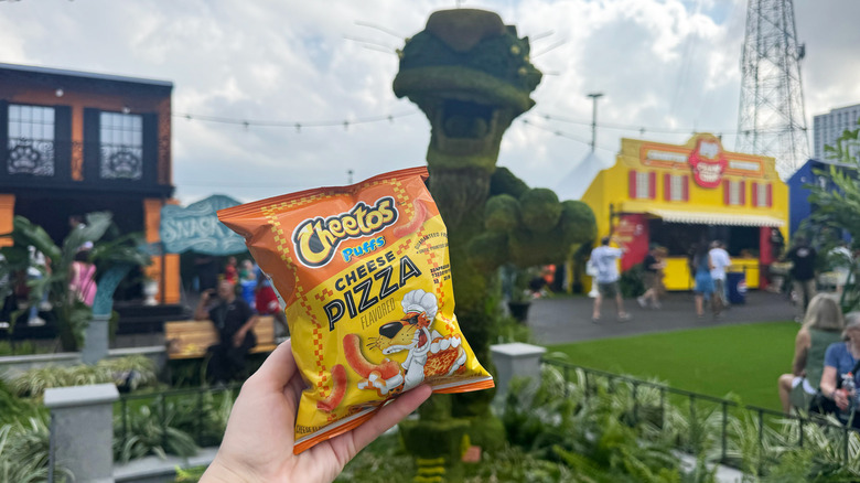 Holding Cheetos Puffs Cheese Pizza at Chips and Sips, NOLA Super Bowl