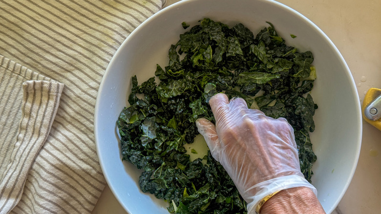 hand massaging kale