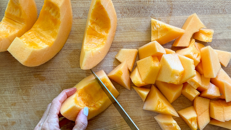 hand chopping cantaloupe