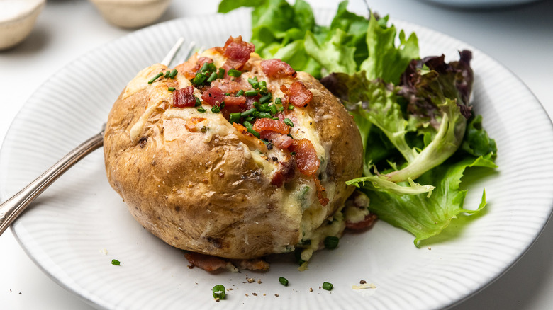 loaded baked potato with salad