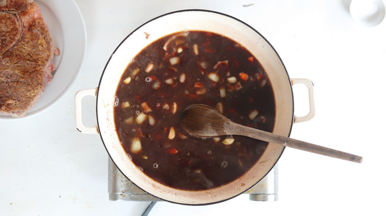 pot of brown liquid and vegetables