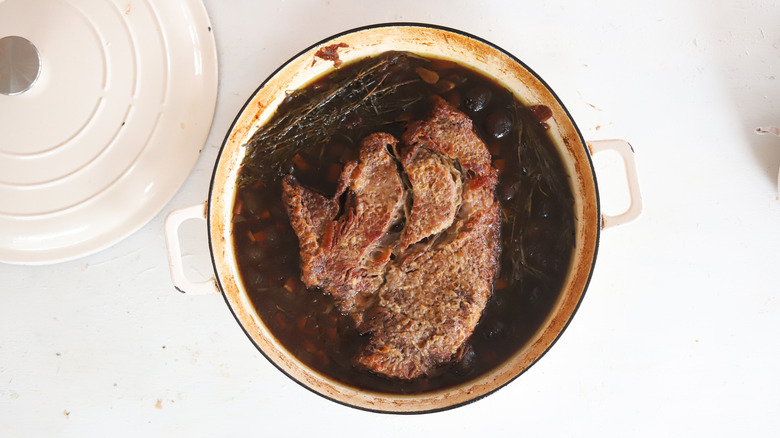 chuck roast in a pot of broth