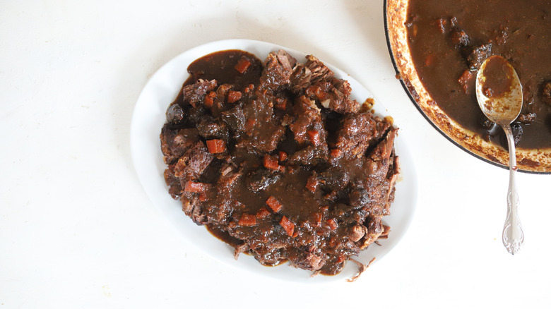 herb and fig pot roast on white serving tray