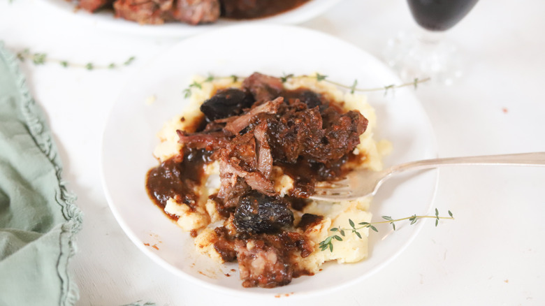 herb and fig pot roast on white serving tray