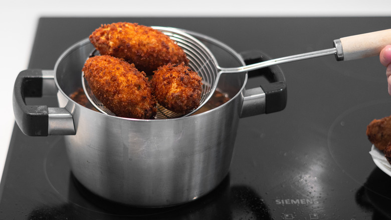 fried croquettes over pot