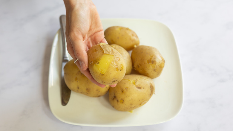 peeling cooked potatoes