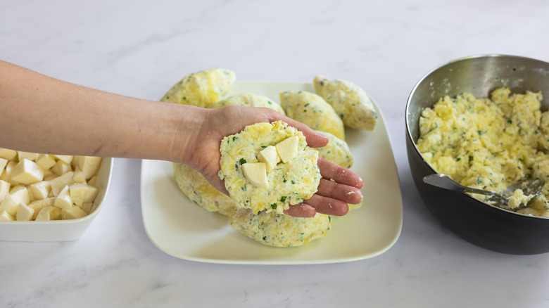 adding cheese to croquette