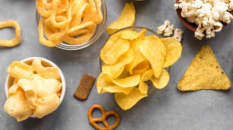 various salty snacks in bowls