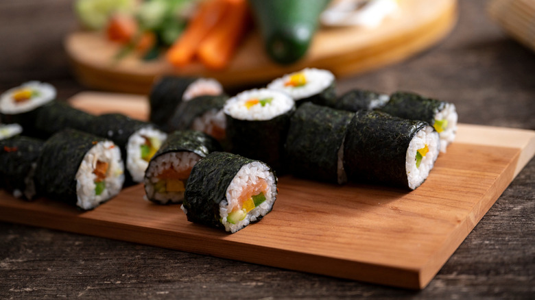 homemade sushi rolls on wooden board