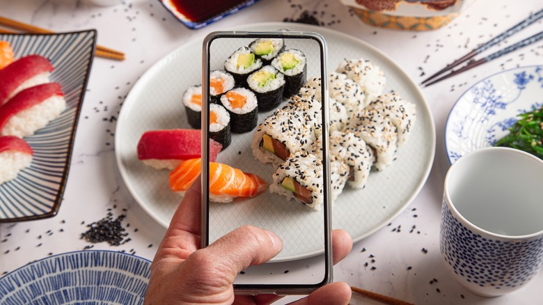 photographing sushi with phone