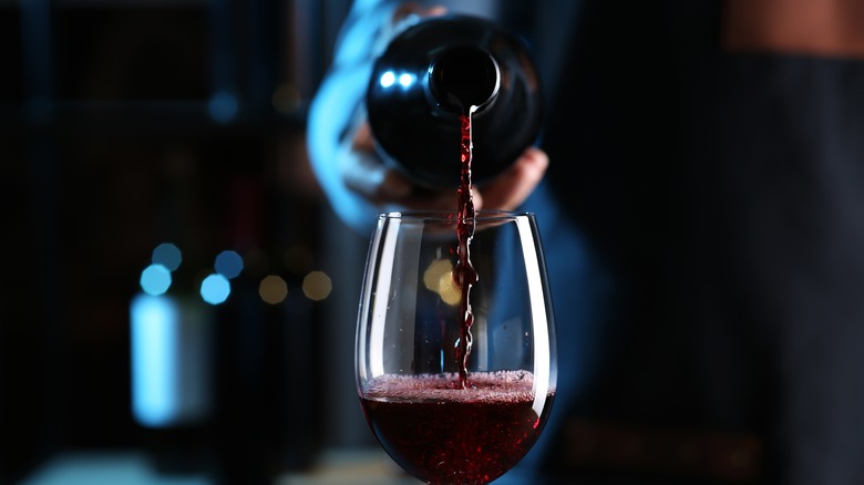dark red wine poured into glass