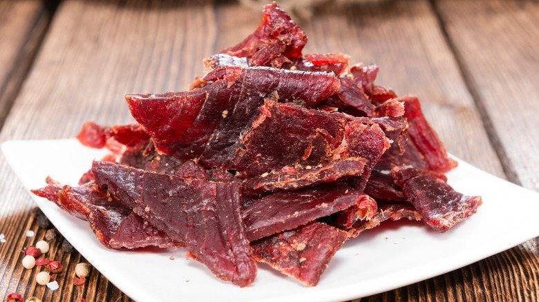 Chopped pieces of red beef jerky on plate