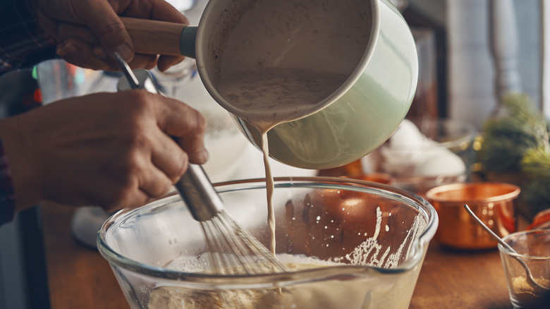 Person pouring liquid into bowl