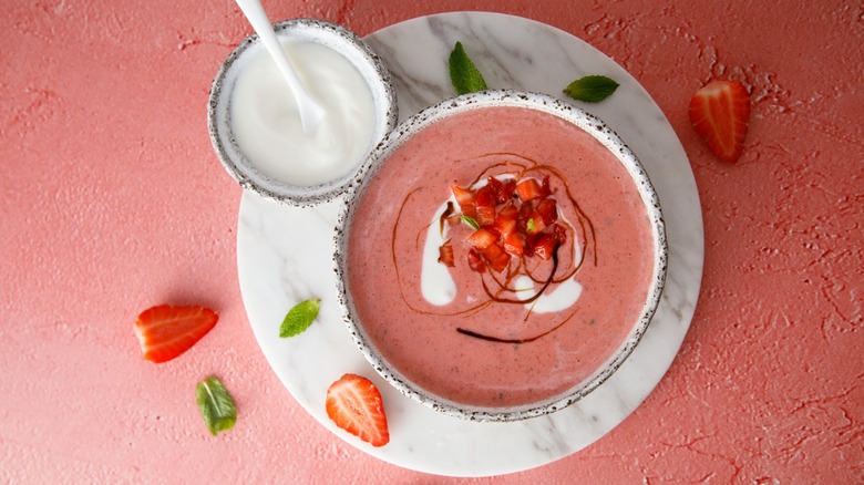 Strawberry soup next to bowl of yogurt