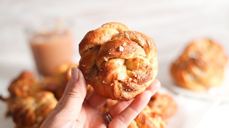 Hand holding cardamom bun