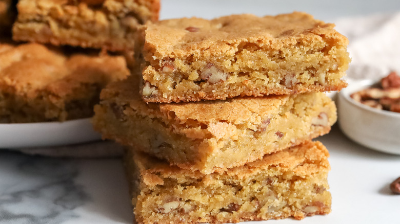 piled squares of light brown bread, cake, or bar cookies
