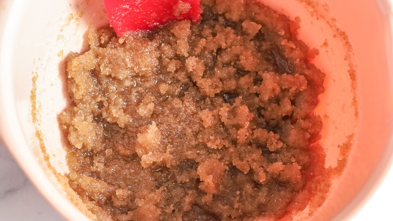 brown crumbly substance in pinkish bowl