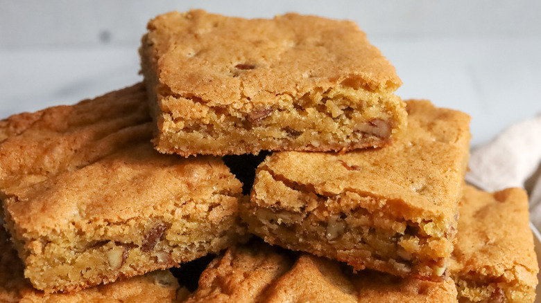 piled squares of light brown bread, cake, or bar cookies