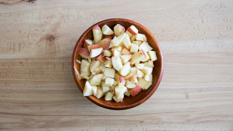 chopped apples in wooden bowl