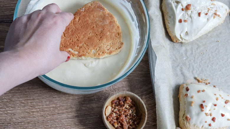 scone dunked in glaze