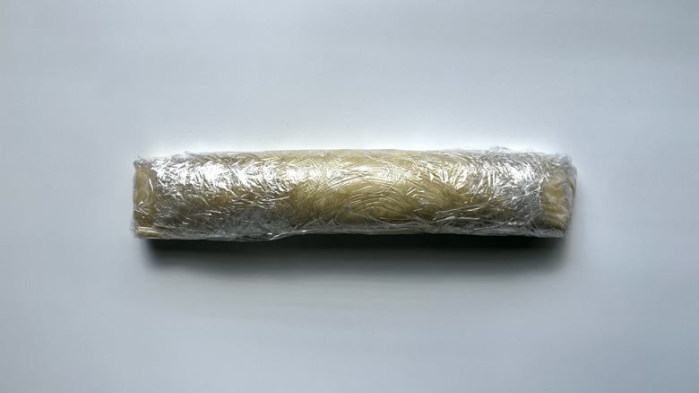 puff pastry log wrapped in plastic wrap