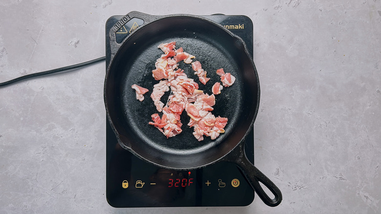 crumbled bacon in skillet