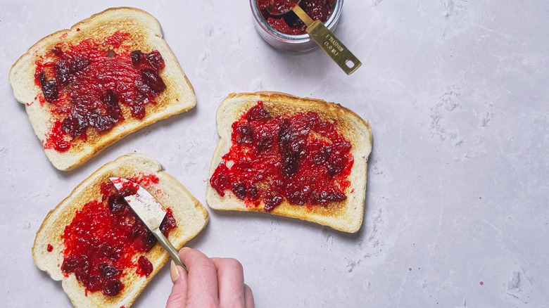 spreading jam onto bread