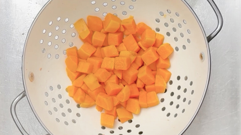 Draining sweet potato in colander