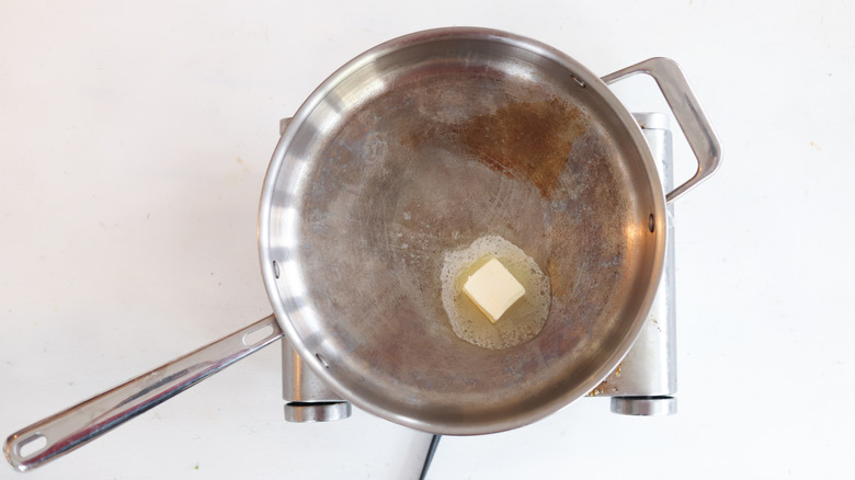 butter heating in metal pan