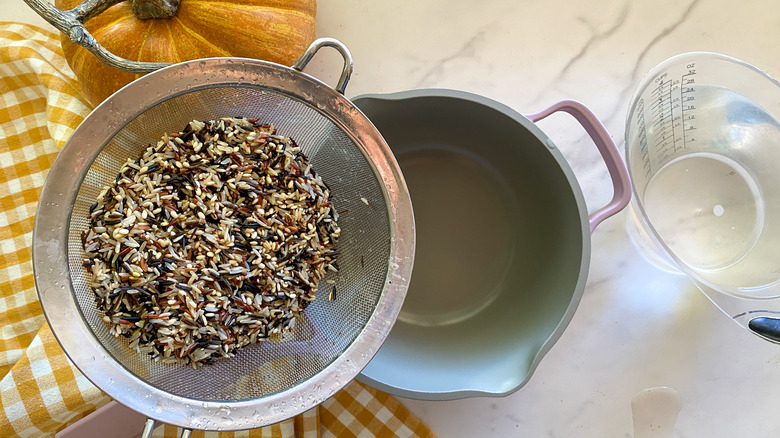 adding rice to pot