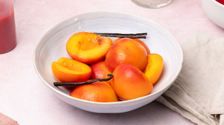 halved peaches in bowl