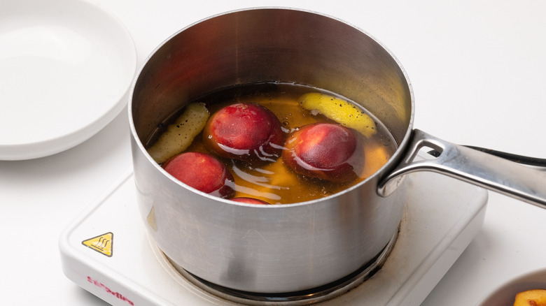 peaches poaching in pan