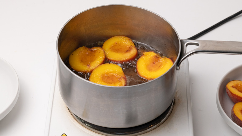 peaches poaching in pan