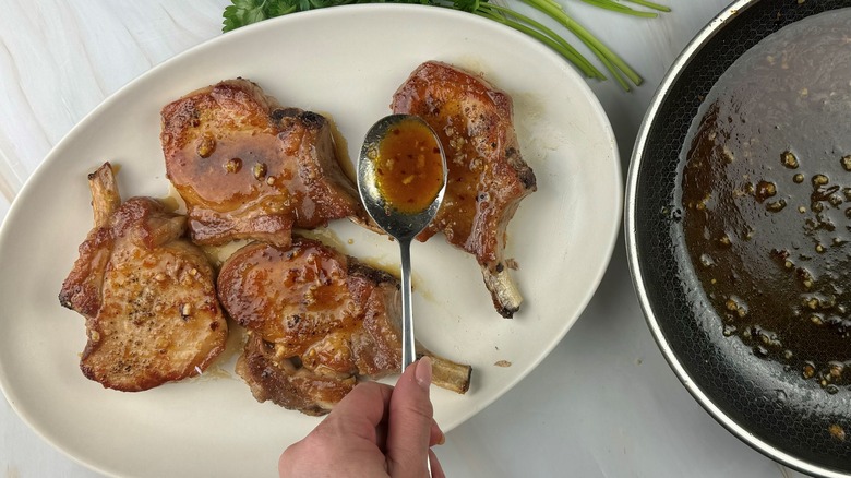 hand applying glaze to chops