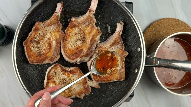 hand applying glaze to chops