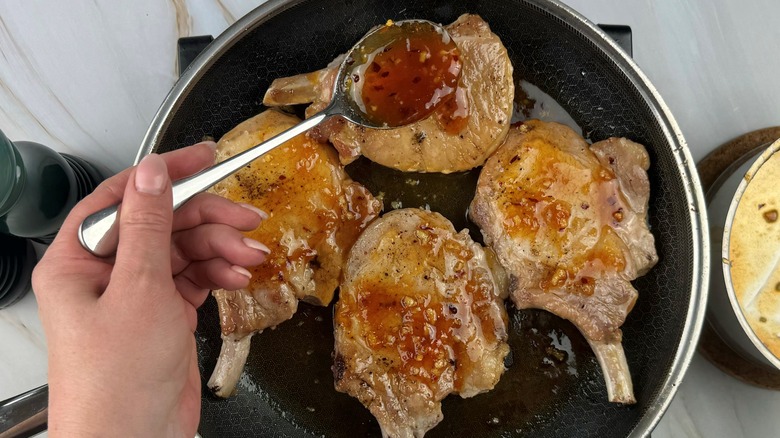 hand applying glaze to chops