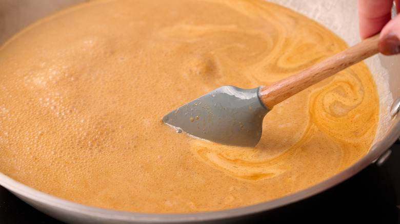 stirring coconut glaze in skillet