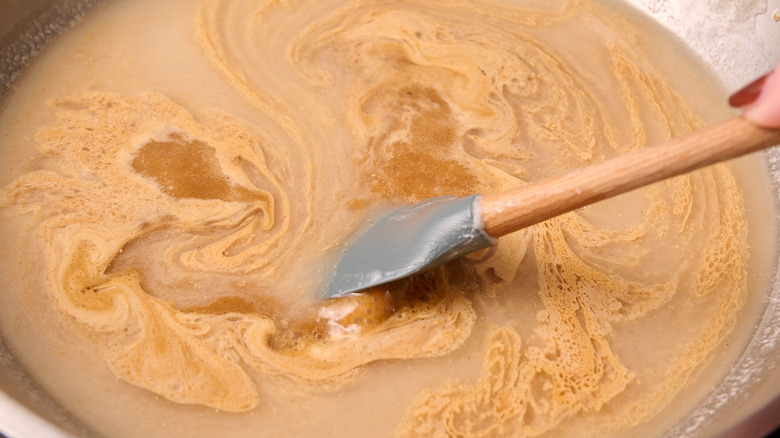 stirring coconut cream in skillet