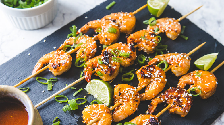 Shrimp skewers on black board