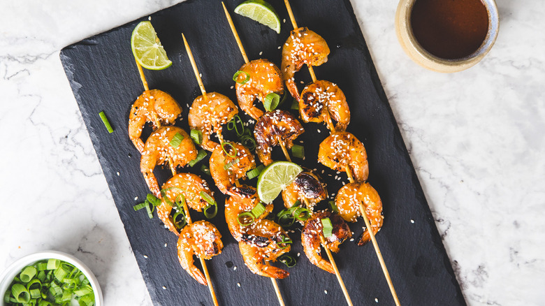 Shrimp skewers on black board