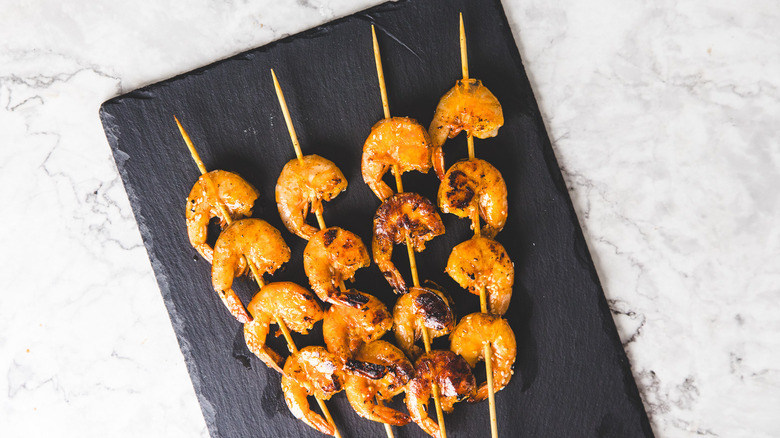 Shrimp skewers on black board