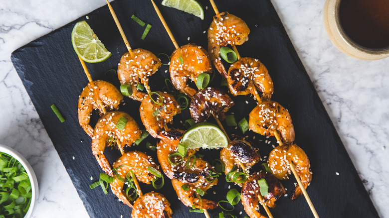 Shrimp skewers on black board