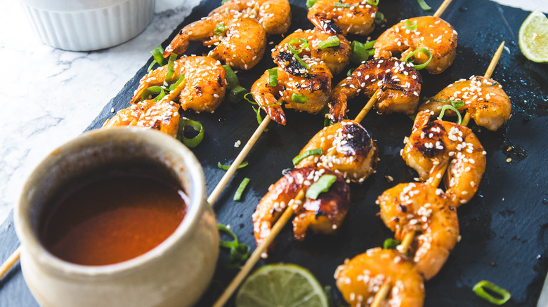 Shrimp on black board with sauce