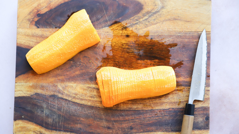 Slicing roasted squash on board