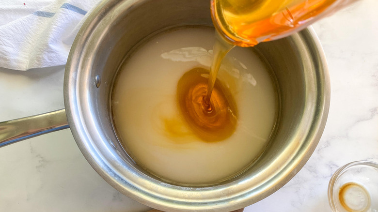 honey poured into pot 