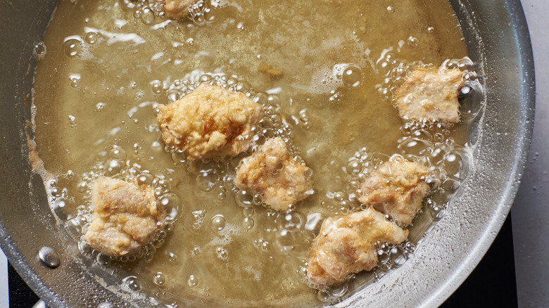 frying pieces of chicken