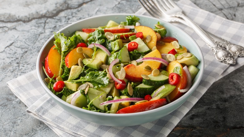 salad with arugula, peaches, and chilis