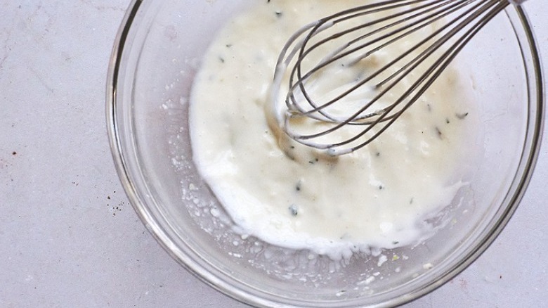 whisking mayonnaise in bowl