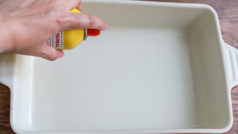 baking pan being greased