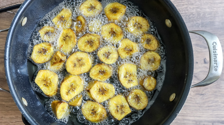 plantain slices frying in a pan